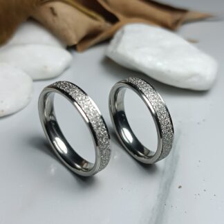 A pair of gold-colored polished steel wedding rings (CODE: 0110)