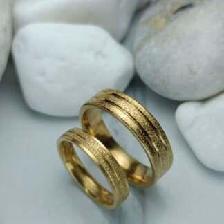 A pair of gold-colored polished steel wedding rings (CODE: 0110)